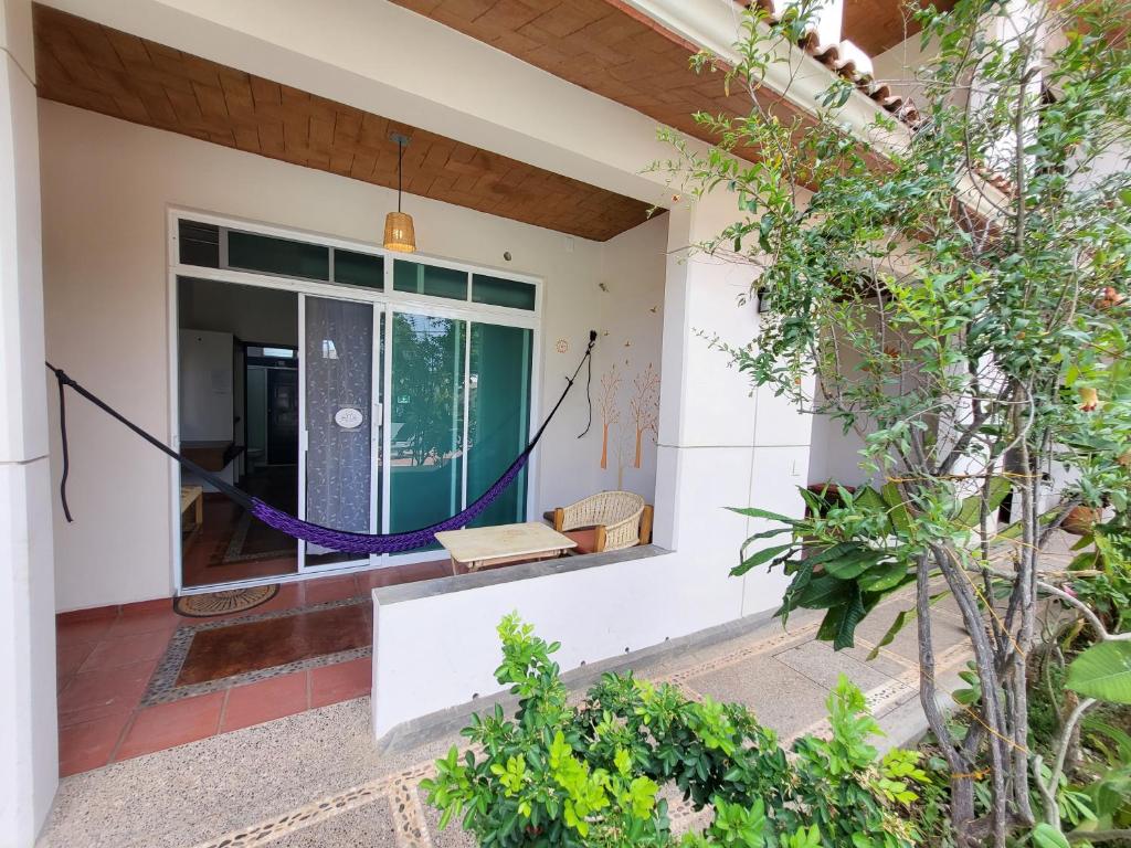 a house with a hammock on the front door at Casa Puerto Bonito & Private Coworking in Puerto Escondido