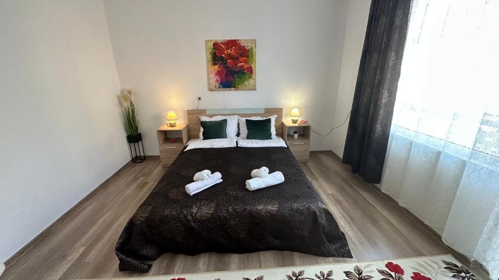 a bedroom with a bed with two towels on it at Apartment ADELINA in Tsarevo