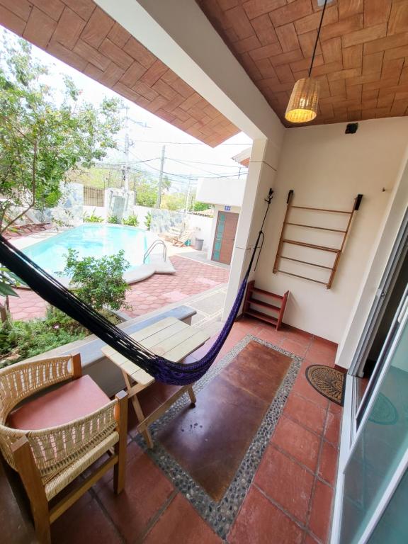 a porch with a hammock and a swimming pool at Casa Puerto Bonito & Private Coworking in Puerto Escondido