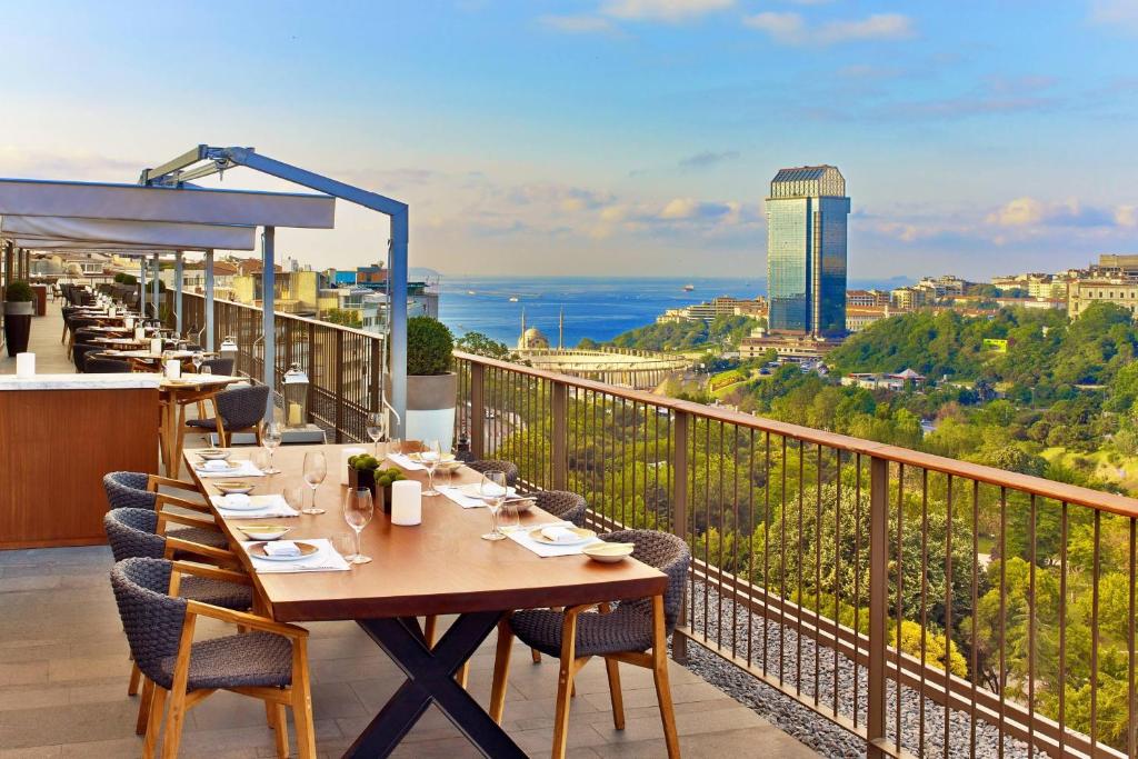 a restaurant with a table and chairs on a balcony at The St. Regis Istanbul in Istanbul