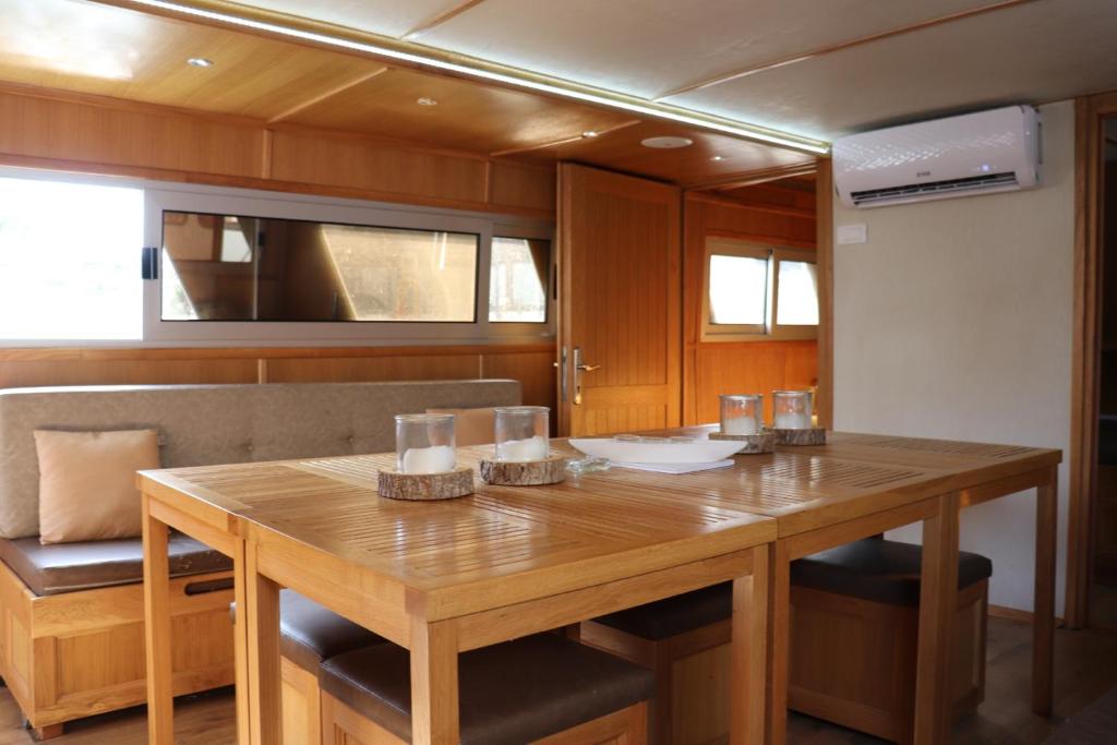 a wooden table and chairs in a boat at Free Room Boat Apartment in Belgrade