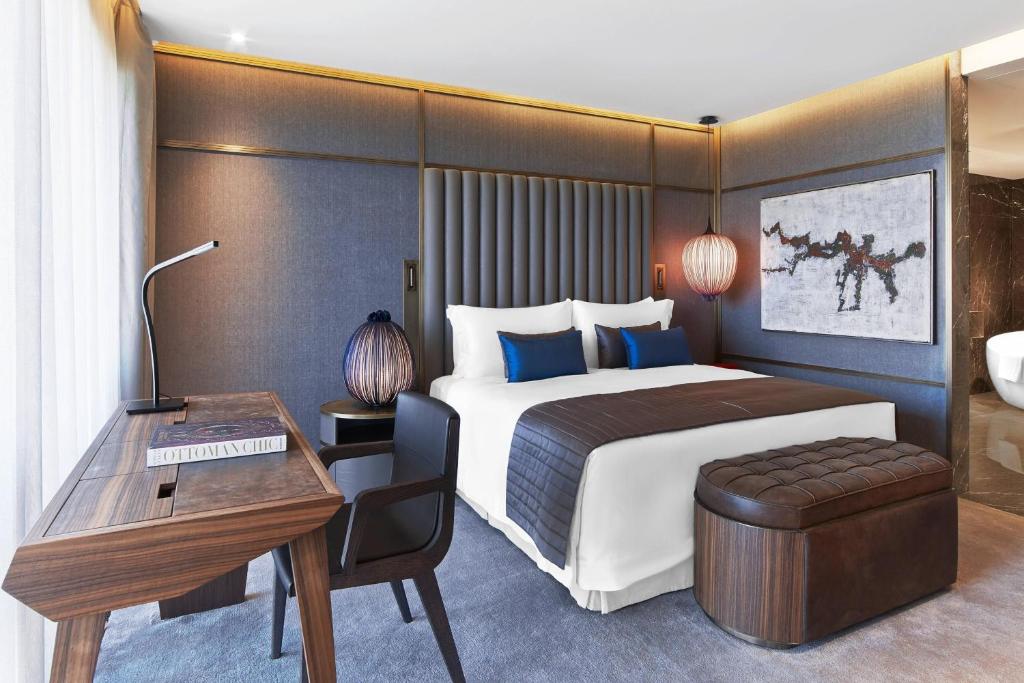 a hotel room with a bed and a desk and a desk at The St. Regis Istanbul in Istanbul