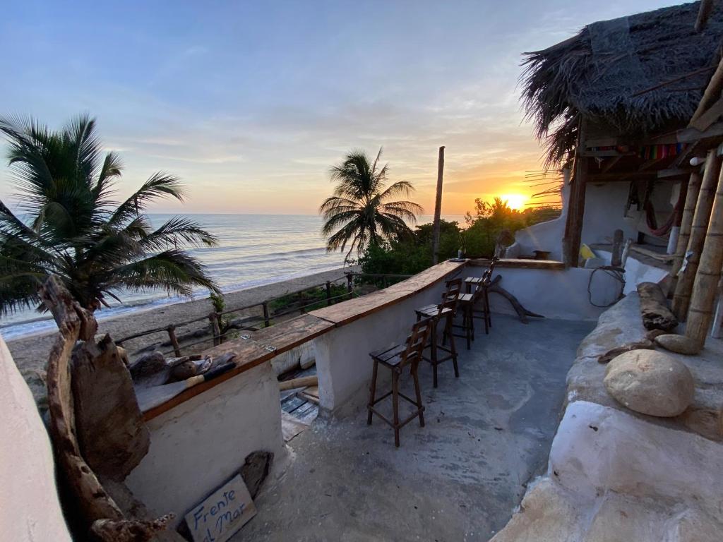 a bar on the beach with a view of the ocean at Frente al Mar in Dibulla