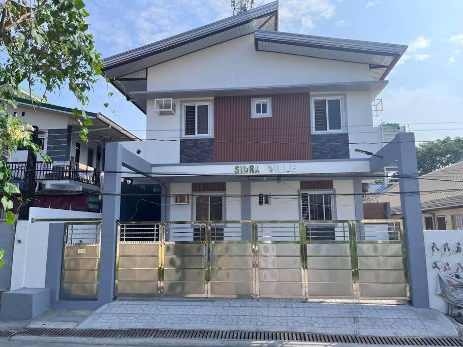 a house with a fence in front of it at Sidra Ville Apartment in Balanga
