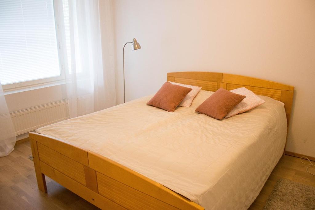 a bedroom with a bed with two pillows on it at Lahti Center House in Lahti