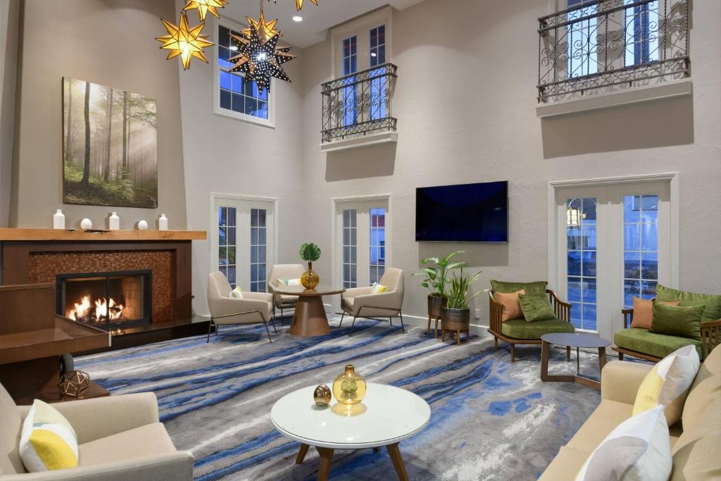 a living room with a fireplace and a tv at Fairfield Inn & Suites San Diego Old Town in San Diego