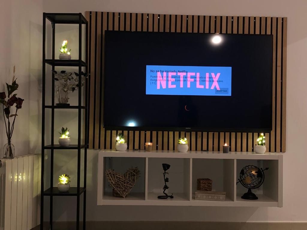 a tv sitting on top of a white entertainment center at Apartaments L’ARC in Palafrugell