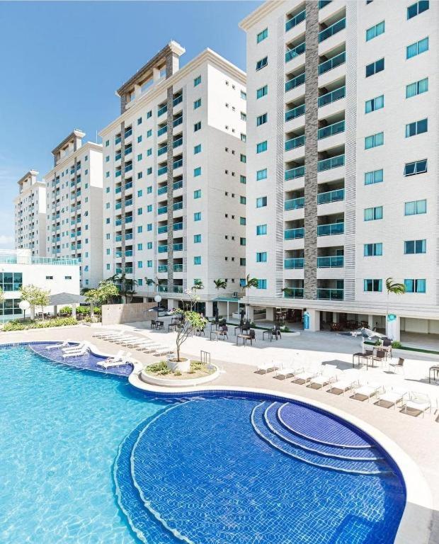 a large swimming pool in front of some tall buildings at Salinas Park Resort in Salinópolis