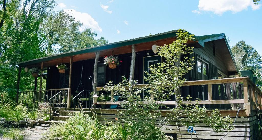 a black house with a porch and some plants at 1 Sweet Retreat in Nashville