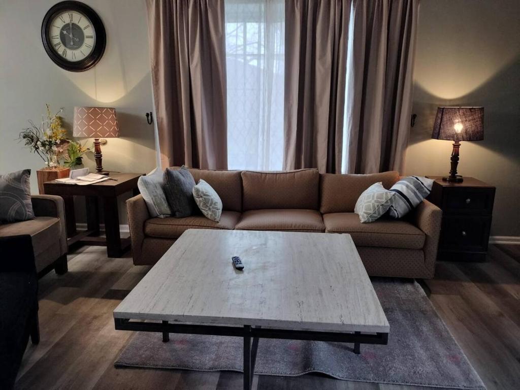a living room with a couch and a coffee table at Lovely green townhouse in Frederick
