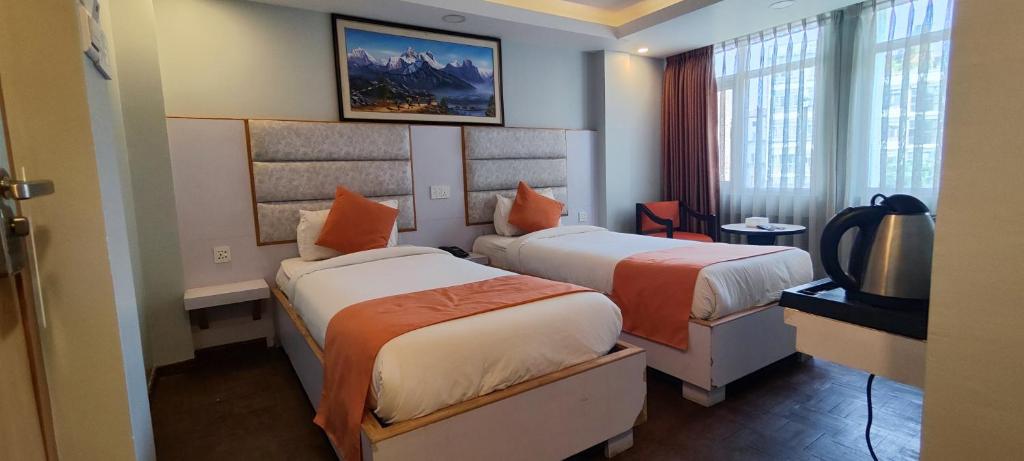 Postel nebo postele na pokoji v ubytování Durbar Hotel & Residence