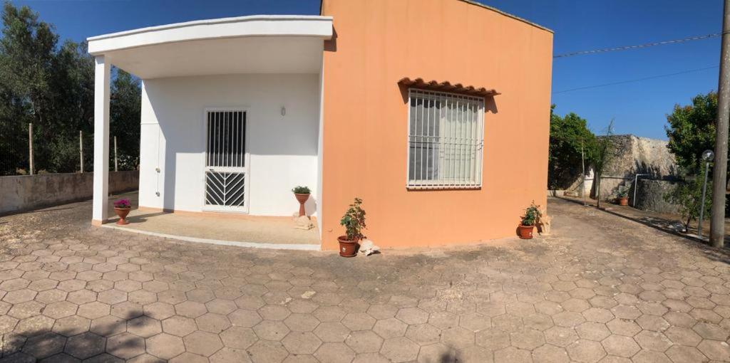 a house with a dog standing in front of it at La campagna di Manuel in Tuglie