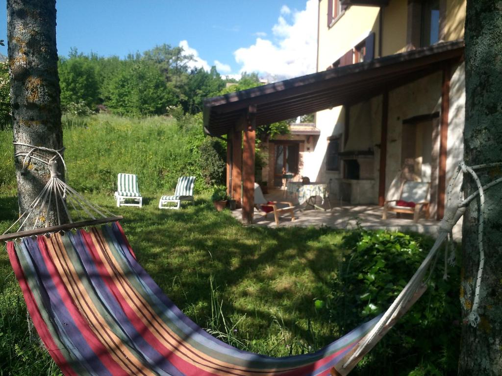 a hammock in a yard next to a house at la Resistance 