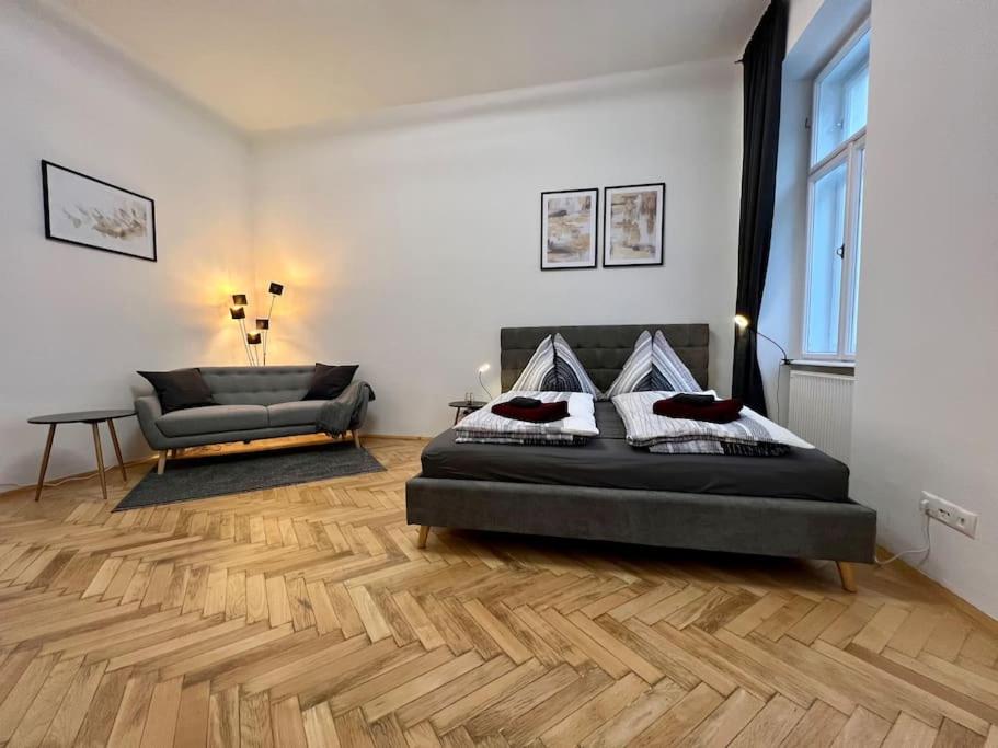 a bedroom with a bed and a chair in it at little cozy residence - enjoy Viennas summer season in Vienna