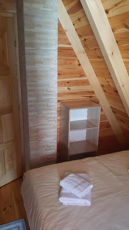 a bedroom with a bed in a wooden attic at House Bojana in Žabljak