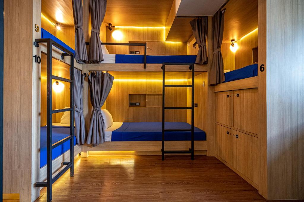 a room with two bunk beds and a hallway at Patong Poshtel in Patong Beach