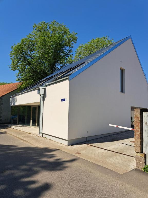 a large white building with a blue roof at Ösel Residence in Kuressaare