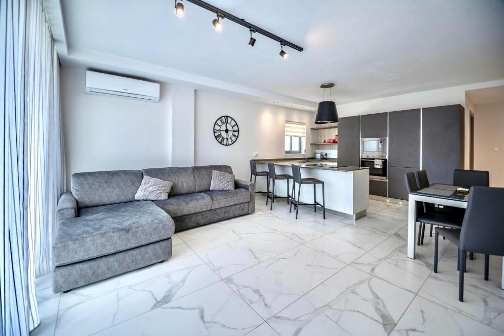 a living room with a couch and a table at Seaside Luxury Apartment in St. Paul's Bay