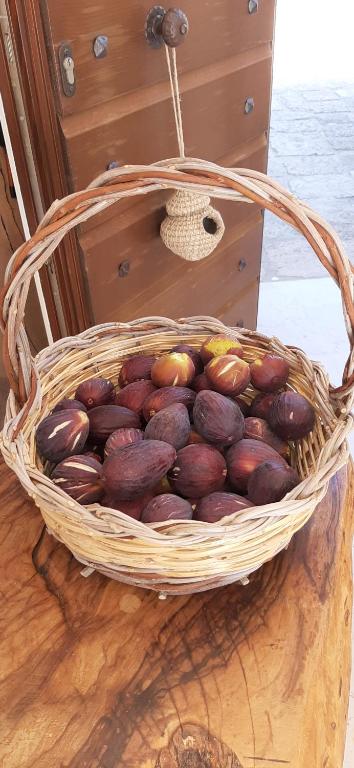a basket of chestnuts sitting on a wooden table at Antica Masseria Ficazzana - Tenuta in Marina di Pescoluse