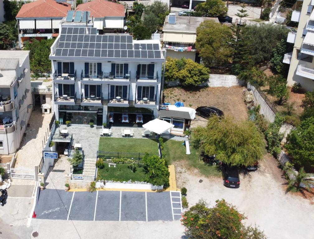 an aerial view of a house with a solar roof at Paradosi Rooms in Igoumenitsa