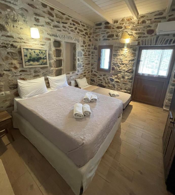 a bedroom with a large bed with towels on it at Marmari Paradise Resort Hotel in Marmari