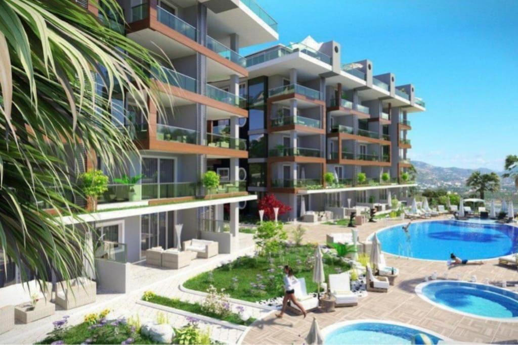 een afbeelding van een appartementencomplex met een zwembad bij Kestel Armani Deluxe for a dream life in Alanya