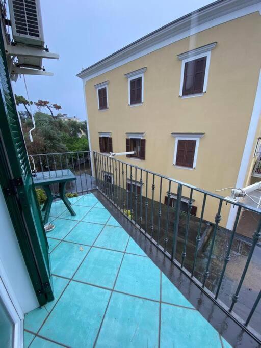 a balcony with a bench in front of a building at Casa Franco in Ischia Town