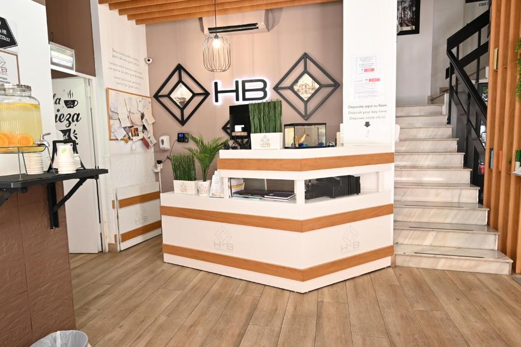 a coffee shop with a staircase in a room at Hostal HB Torrevieja in Torrevieja