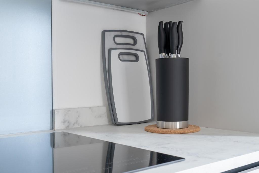 a kitchen counter with a knife and utensils at Hemel Apartments- City Zen in Hemel Hempstead