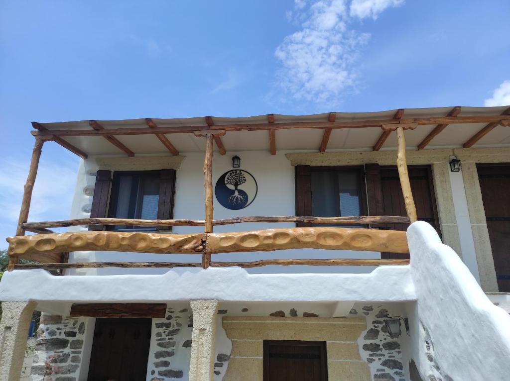 a balcony of a house with a sign on it at Orange Garden Double Rooms in Kala Nera