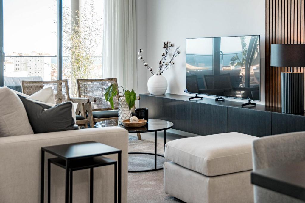 a living room with a couch and a tv at LME144A Spacious & luxury family home in Estepona