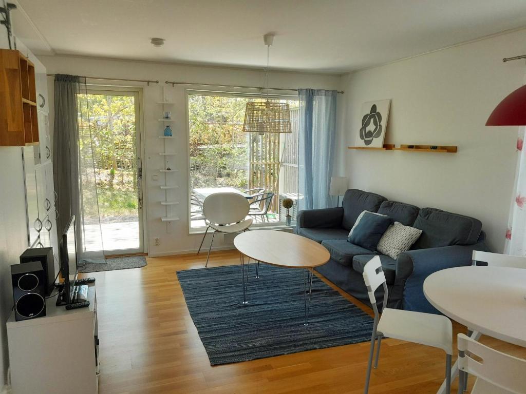 a living room with a blue couch and a table at Lovely holiday apartment in Mellbystrand in Mellbystrand