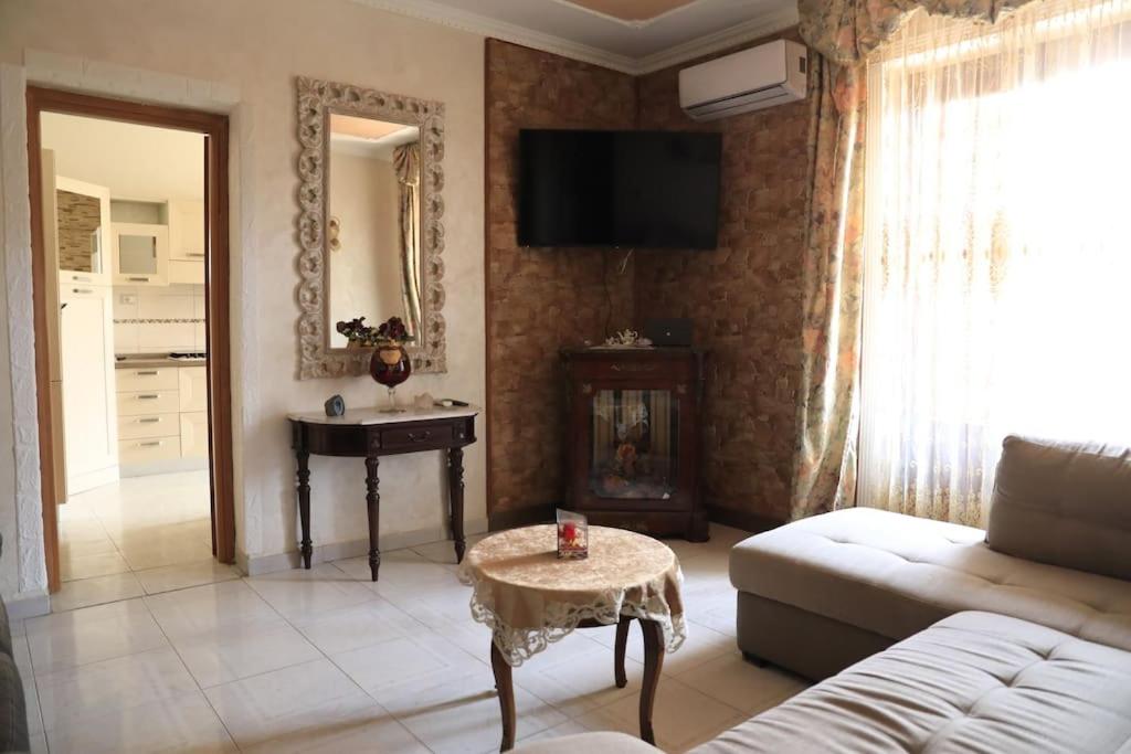 a living room with a couch and a table at Due minuti dal mare con Balcone in Tropea