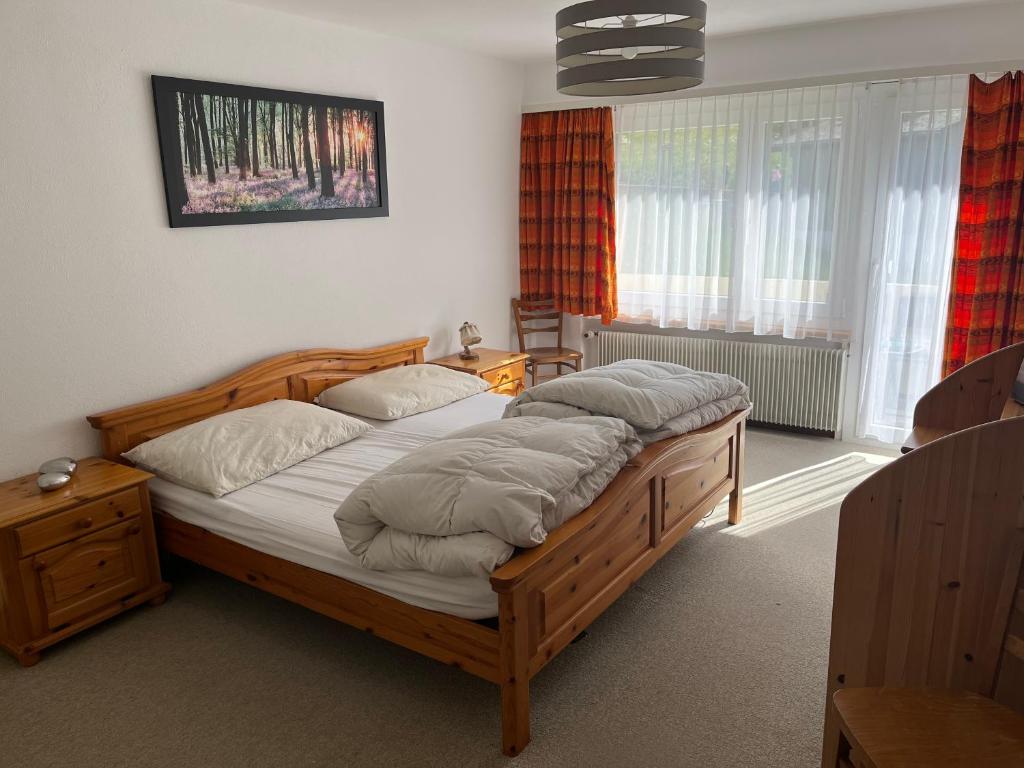 a bedroom with a large wooden bed with pillows at annelise in Leukerbad