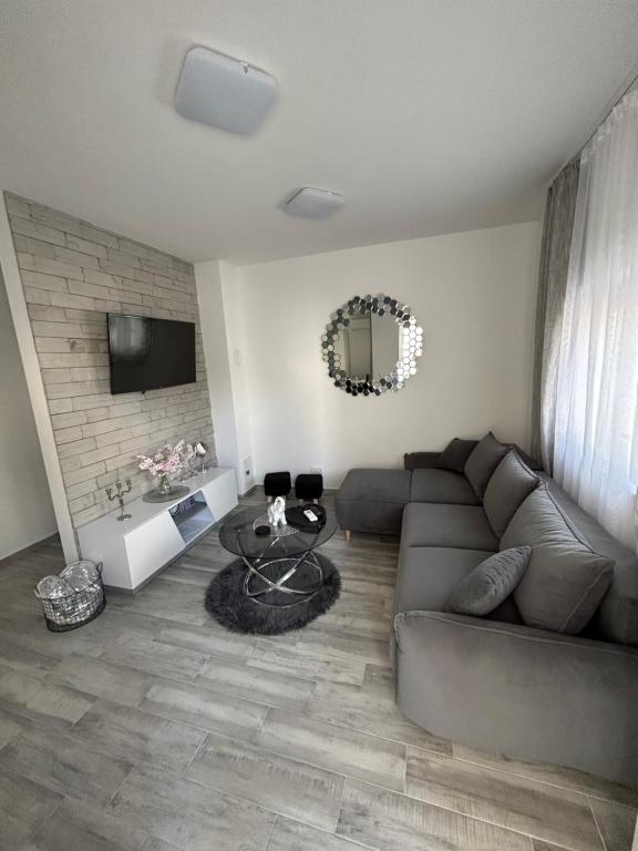 a living room with a couch and a table at Apartman Petra in Vir