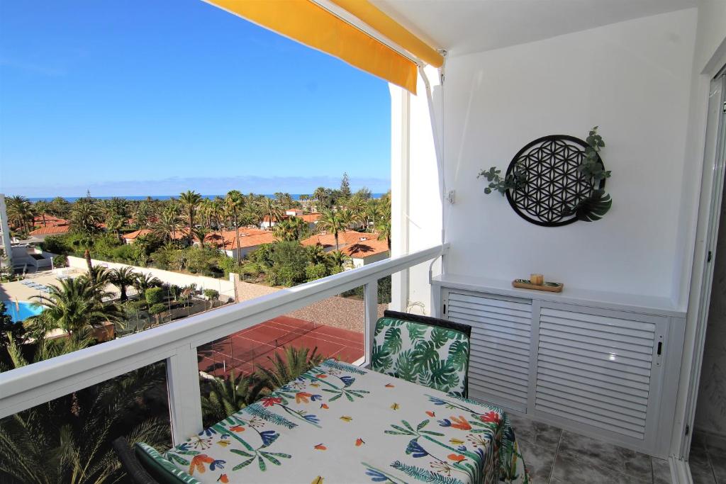 a balcony with a seat and a view of the ocean at Apartments ALOE TOP FLOOR in Playa del Ingles