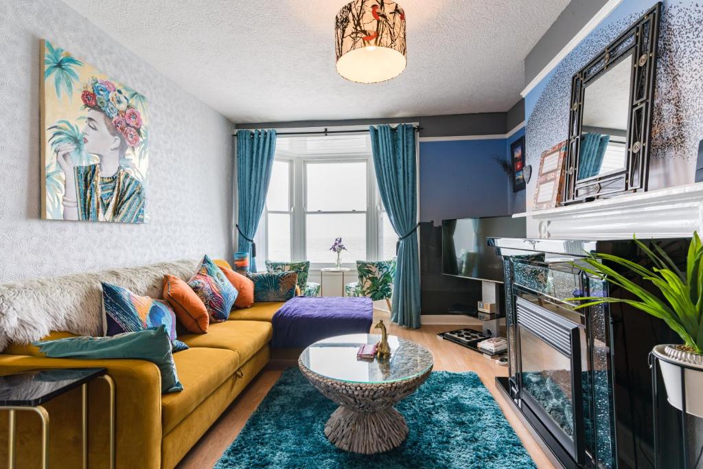 a living room with a couch and a tv at Starling View BOUTIQUE Stunning Seafront view Apartment in Aberystwyth