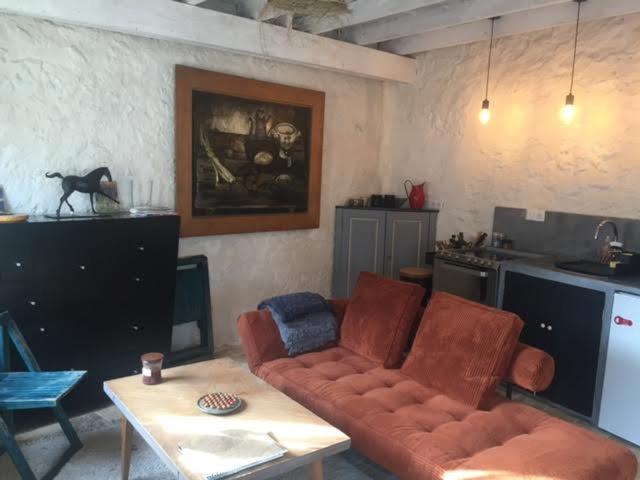 a living room with a couch and a table at Charmante maisonnette en duplex au pied du Château in Nogent-le-Rotrou