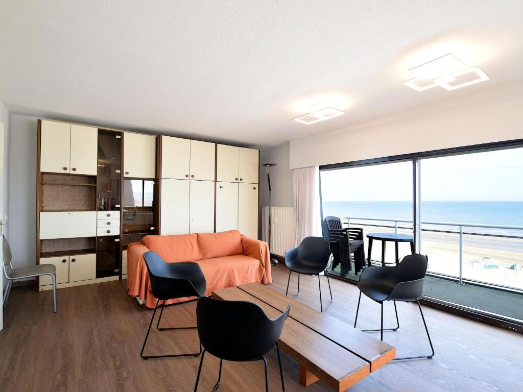 a living room with a view of the ocean at Golf 0401 seafront apartment with balcony in De Haan