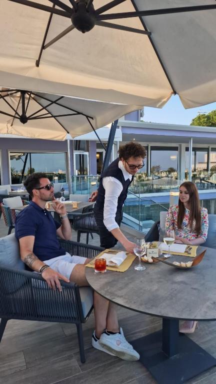 a man sitting at a table with a plate of food at Fantinello Hotel in Caorle