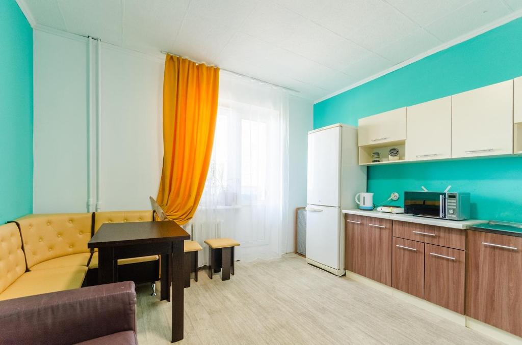 a kitchen with a couch and a table in a room at HOSTEL 95 in Kyiv