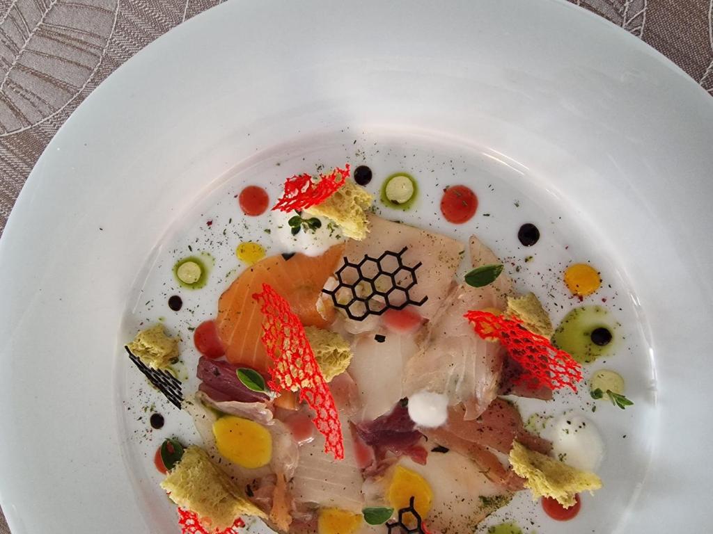 a white plate of food on a table at Fantinello Hotel in Caorle