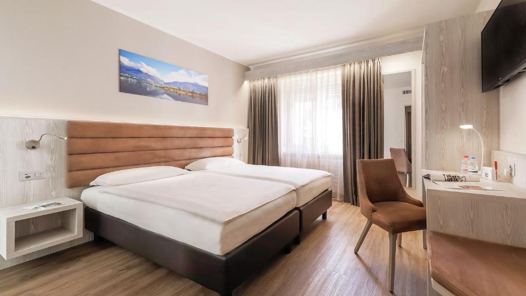 Postel nebo postele na pokoji v ubytování Hotel La Perla