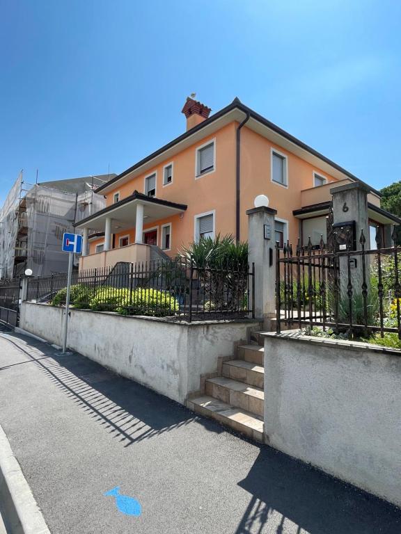 a house with a fence in front of a street at Apartment Sotlar in Izola