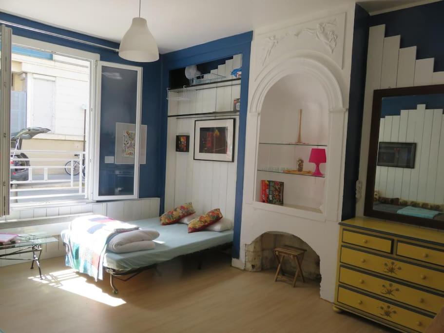 a living room with a bed and a fireplace at Studio (T1) quartier Cathédrale in Tours
