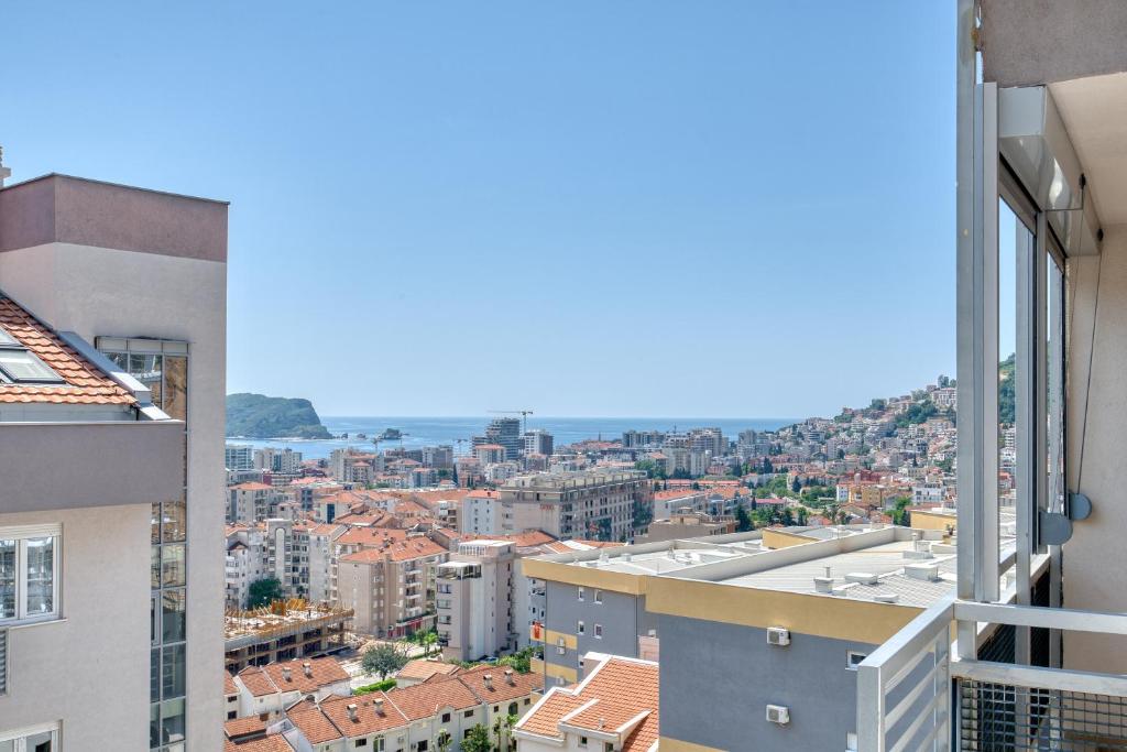 a view of the city from the balcony of a building at Sigma apartment in Budva