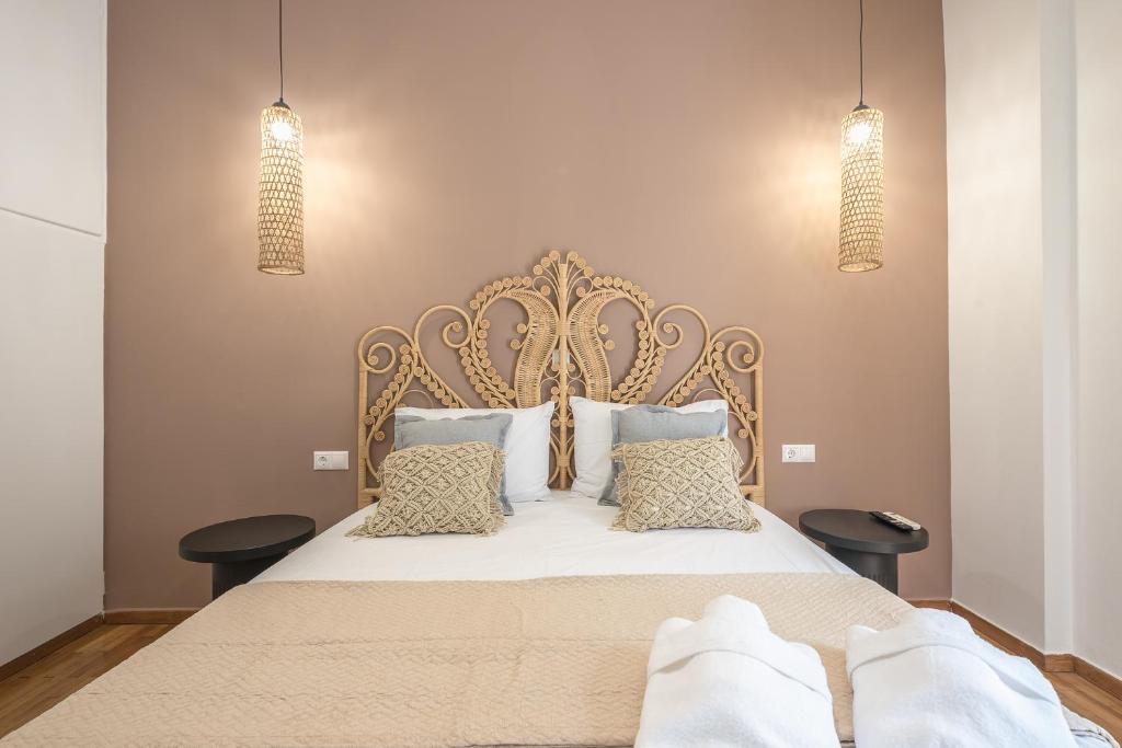 een slaapkamer met een groot bed met witte lakens en kussens bij Nomad Pennie Home by CloudKeys in Athene