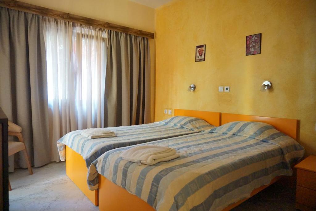 sypialnia z łóżkiem i dwoma ręcznikami na nim w obiekcie Katerini Apartments Hotel w mieście Platanes