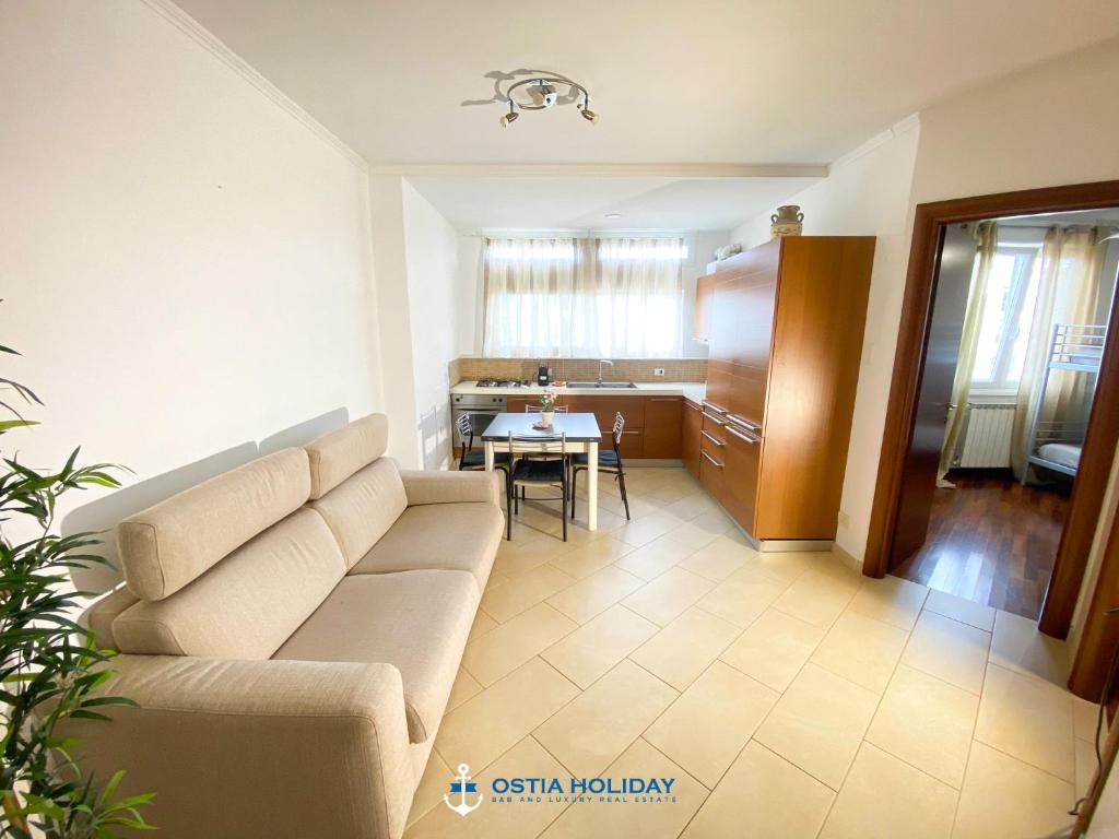 a living room with a couch and a table at Ostia Holiday Tancredi Chiaraluce in Lido di Ostia