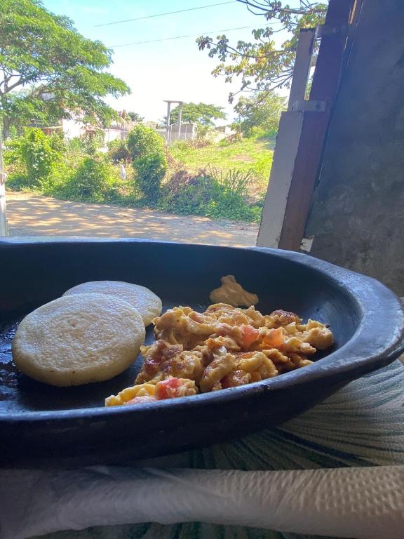 a blue dish of food with a tortilla next to at Ekaa Hotel in Palomino